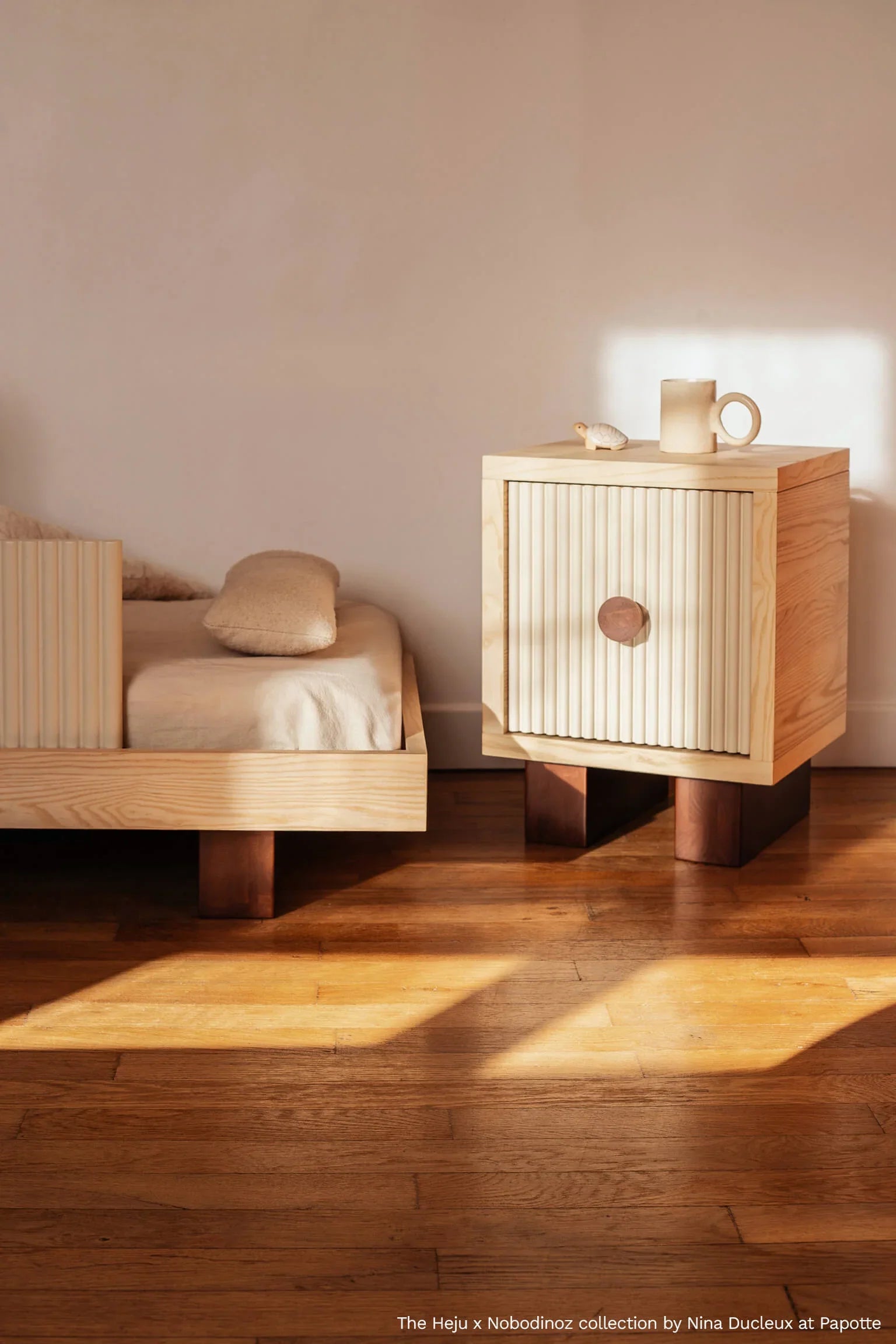Heju x Nobodinoz wooden bedside table with ribbed cream door in sunlit room