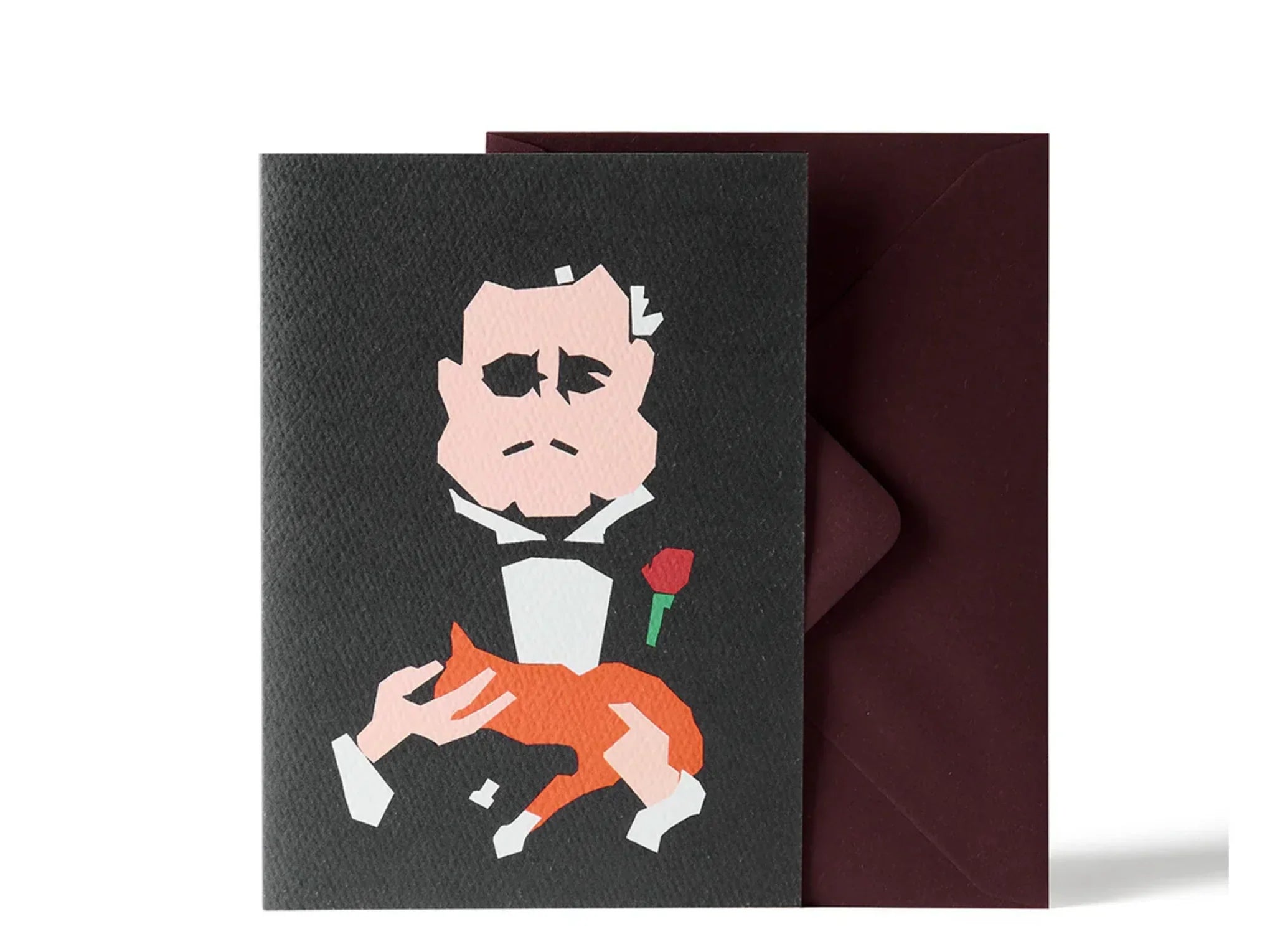 Impaper premium black textured paper greeting card with minimalist tuxedo man illustration, red rose, and brown pet, paired with a deep burgundy envelope.
