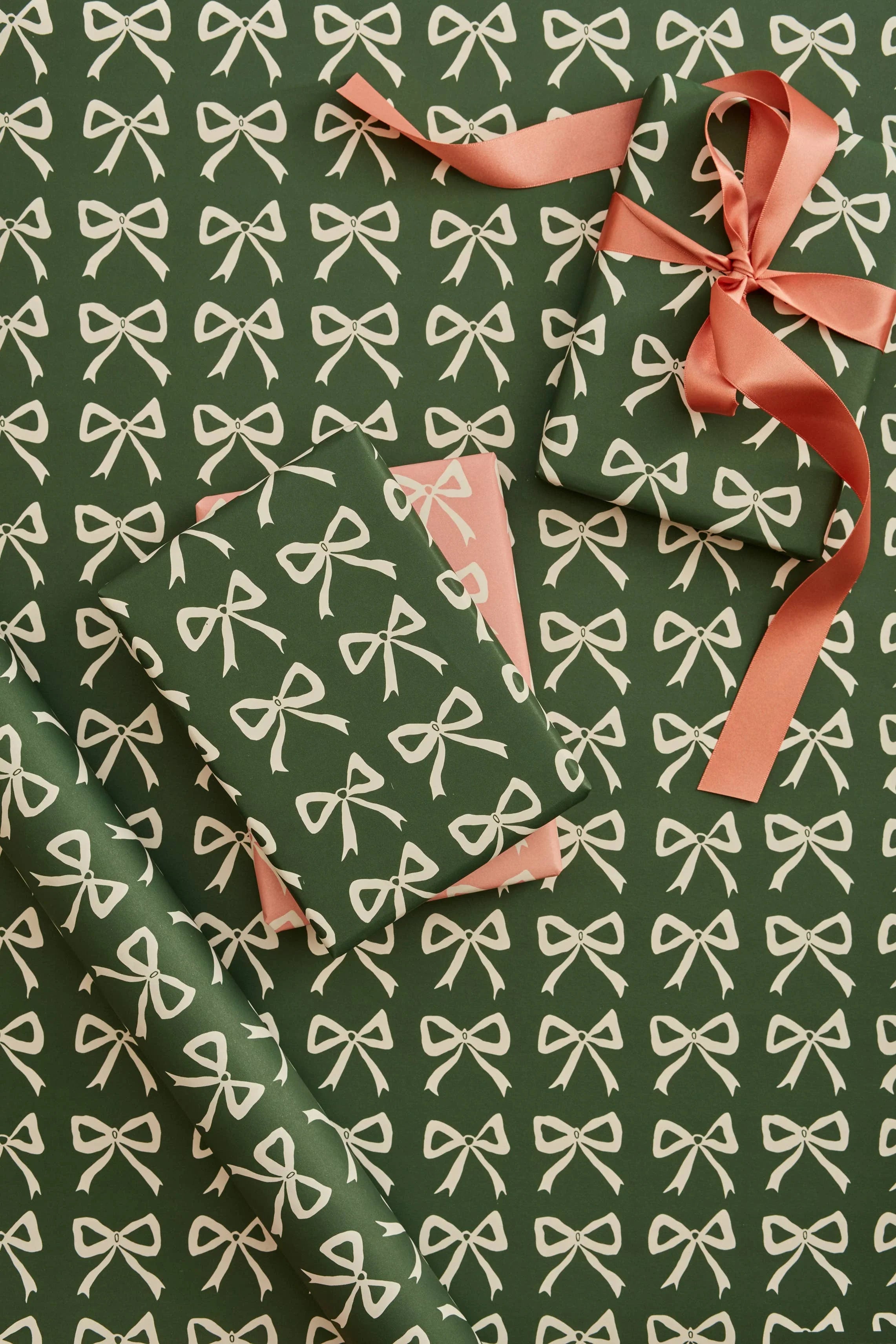 Dogwood Hill green gift wrap paper with white bow pattern, premium matte finish, peach ribbon