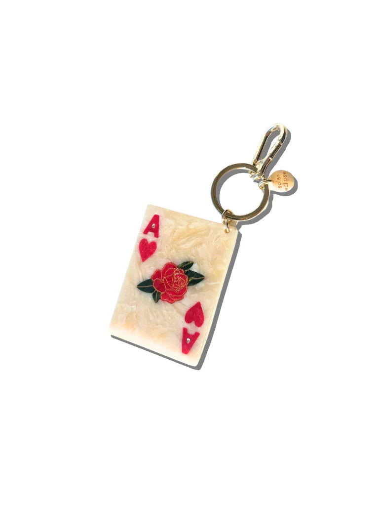 Solar Eclipse Ace of Hearts resin keychain with gold hardware, red floral detail