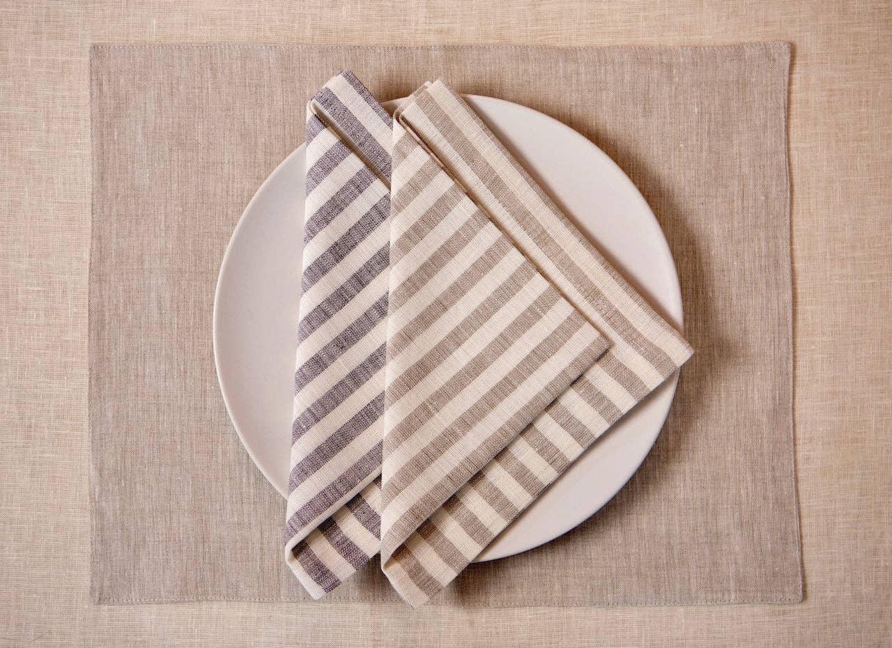 Linen Tales linen striped napkins in beige and grey on white plate, beige linen placemat