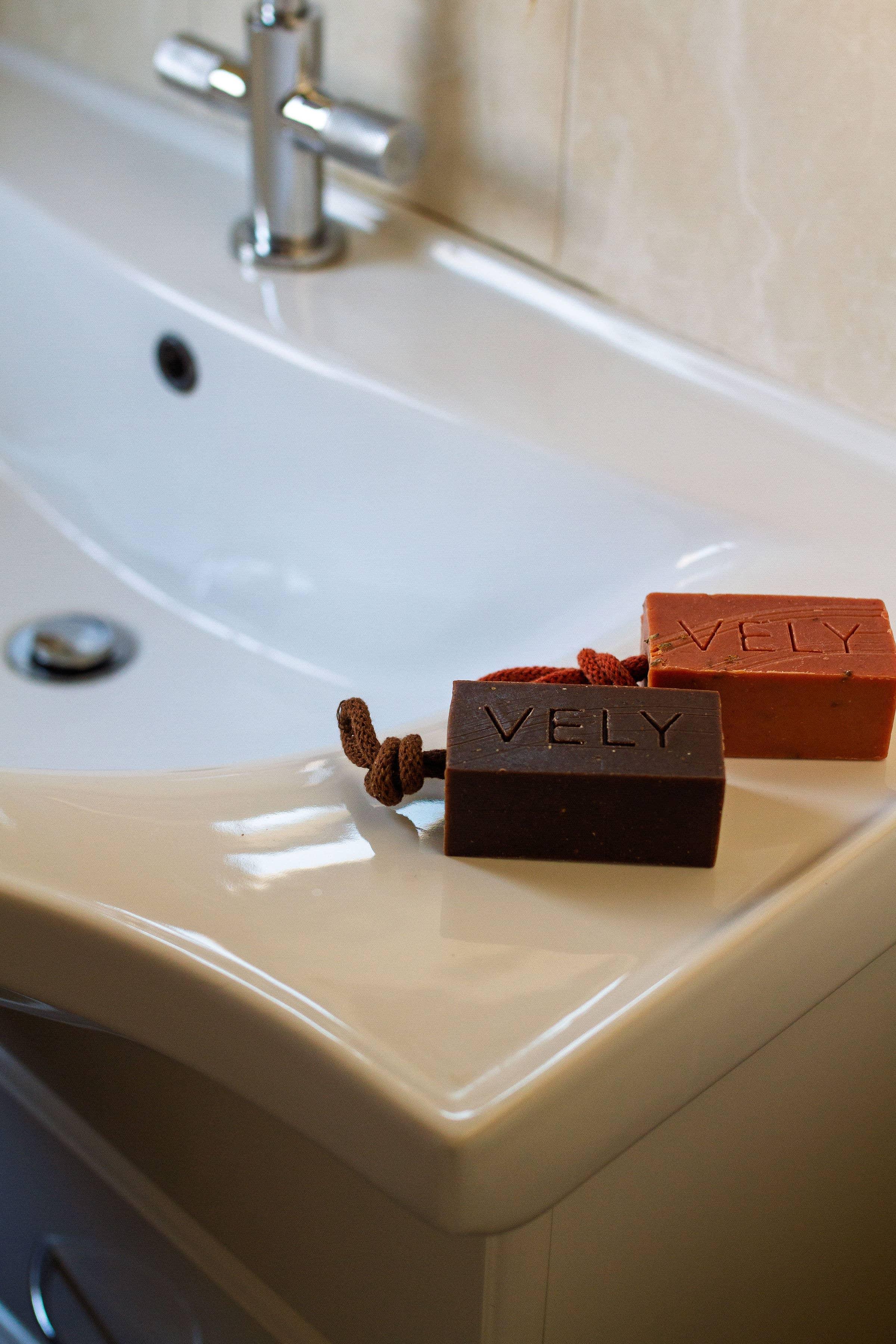 VELY artisan soap bars in brown and terracotta, natural ingredients, on modern sink