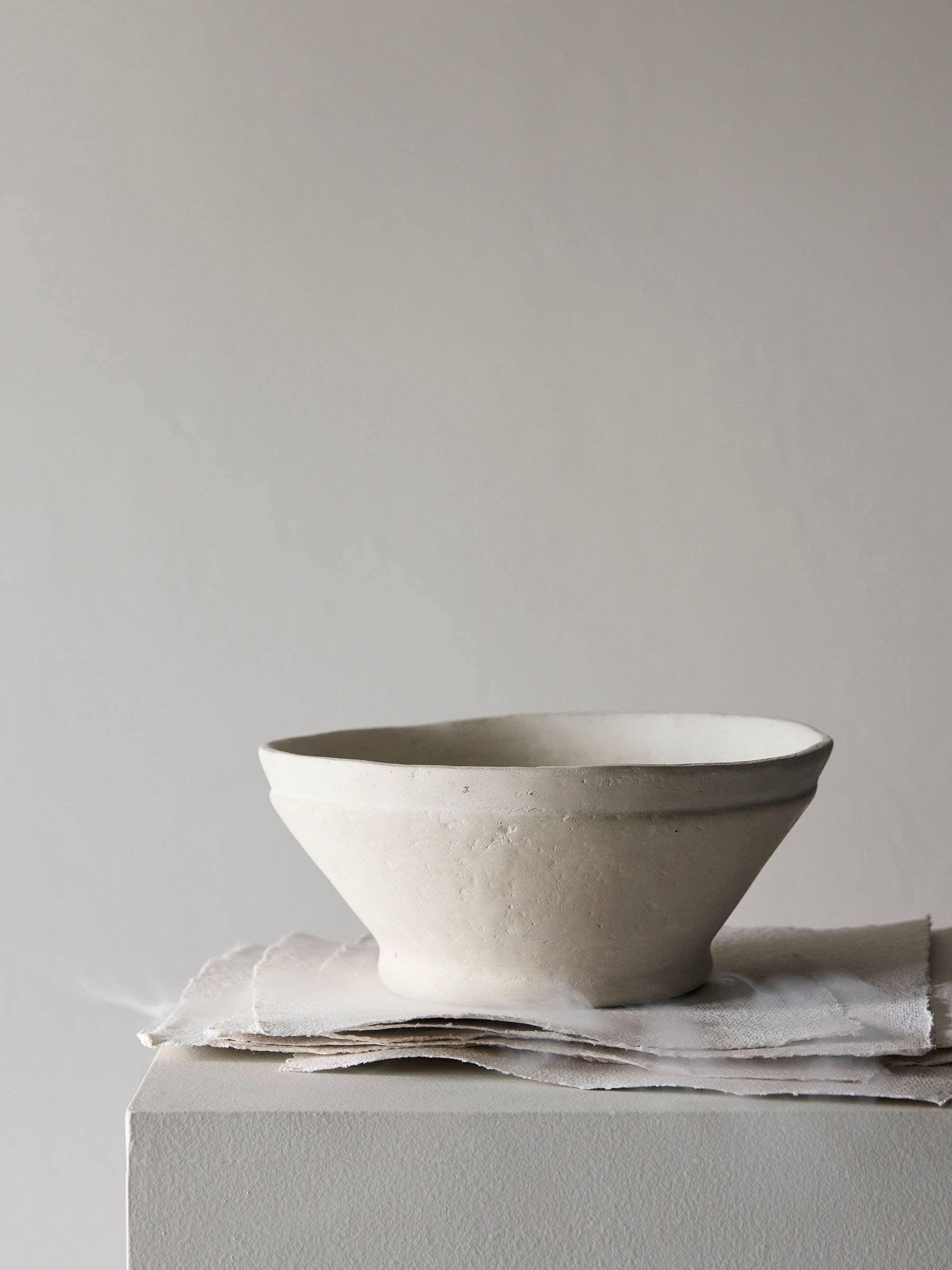 Mellow pottery handmade white ceramic bowl on linen napkins, minimalist premium decor