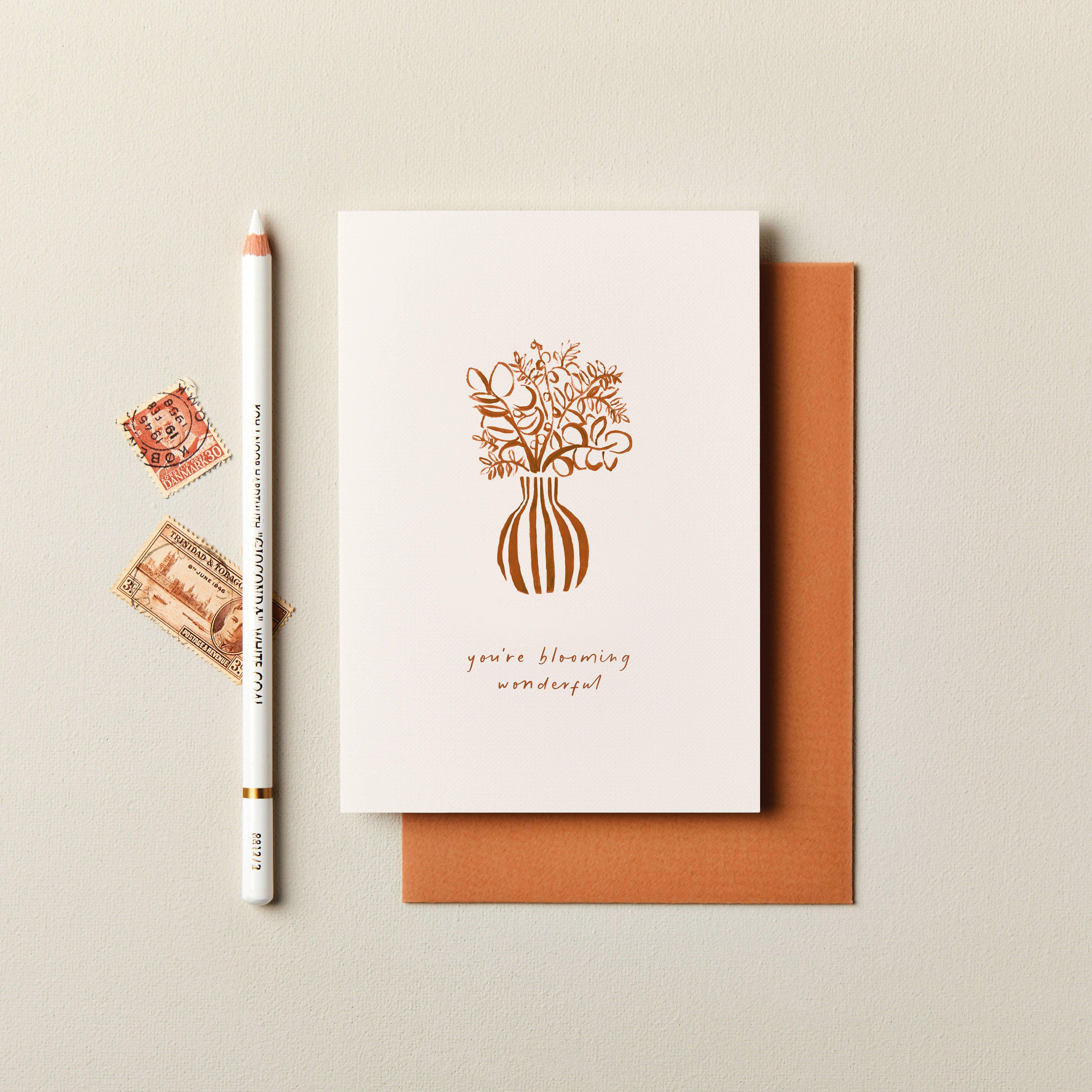 Rifle Paper Co. greeting card with gold foil floral vase design, white pencil, orange envelope
