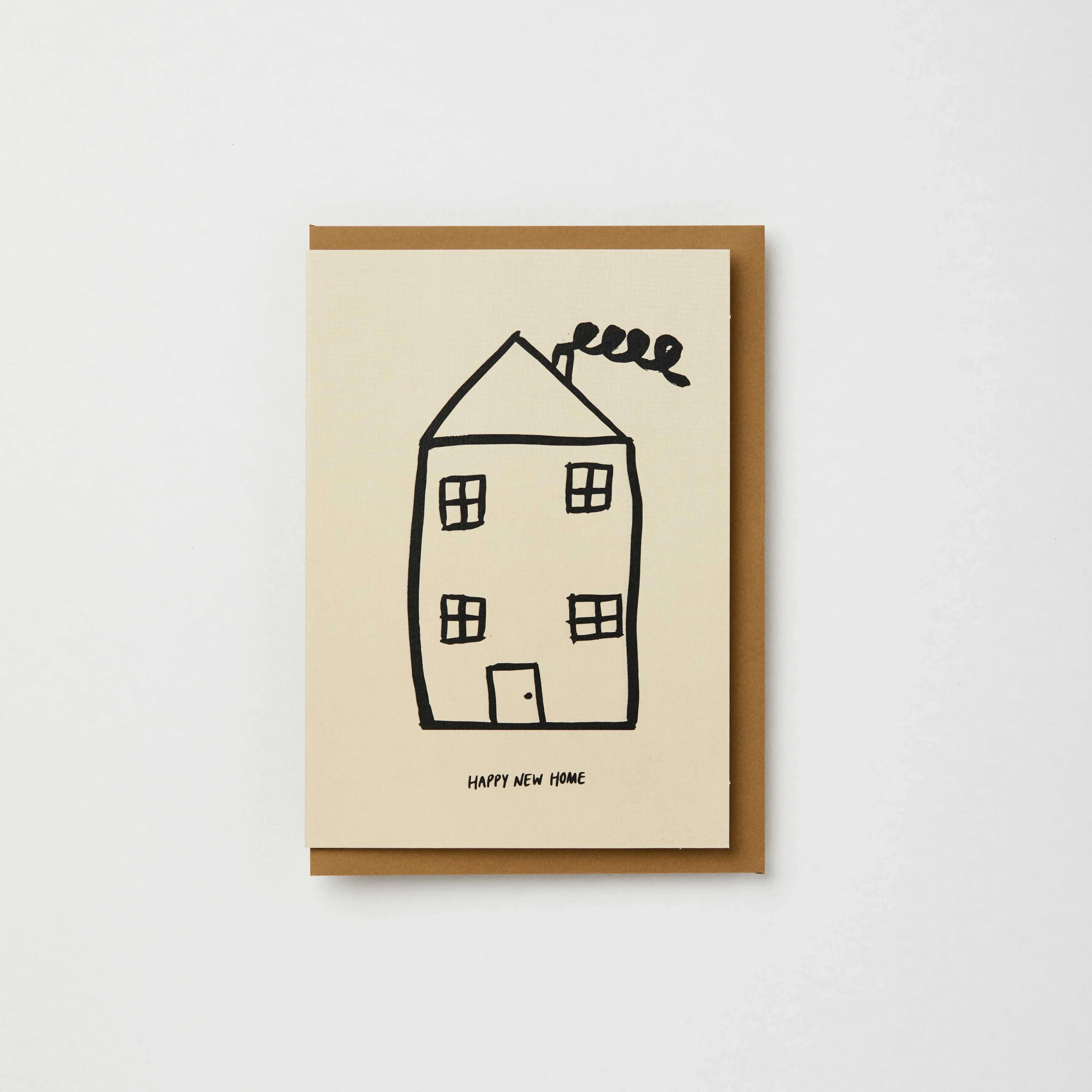 The Completist Happy New Home card, premium textured paper, minimalist cream and black design.