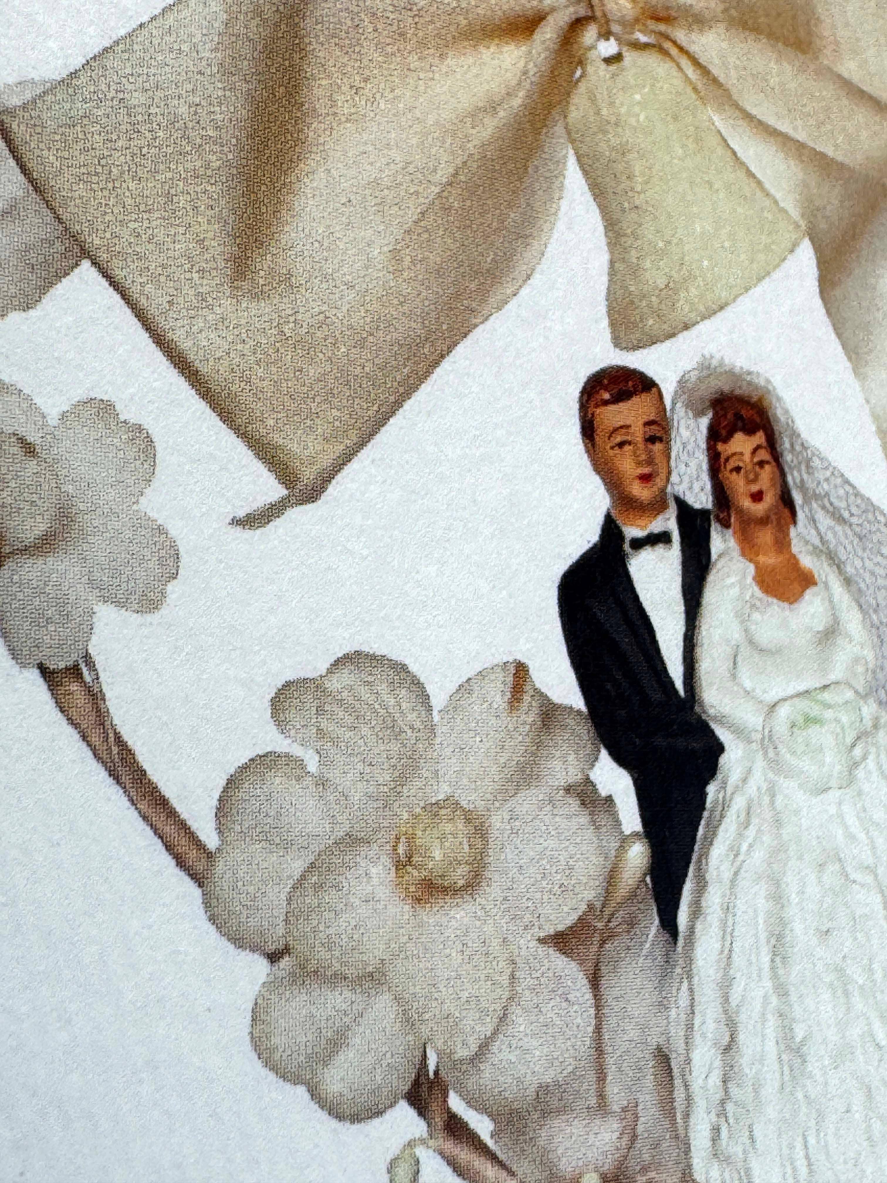 Vintage wedding cake topper with bride and groom figurines, ivory flowers, and fabric bow