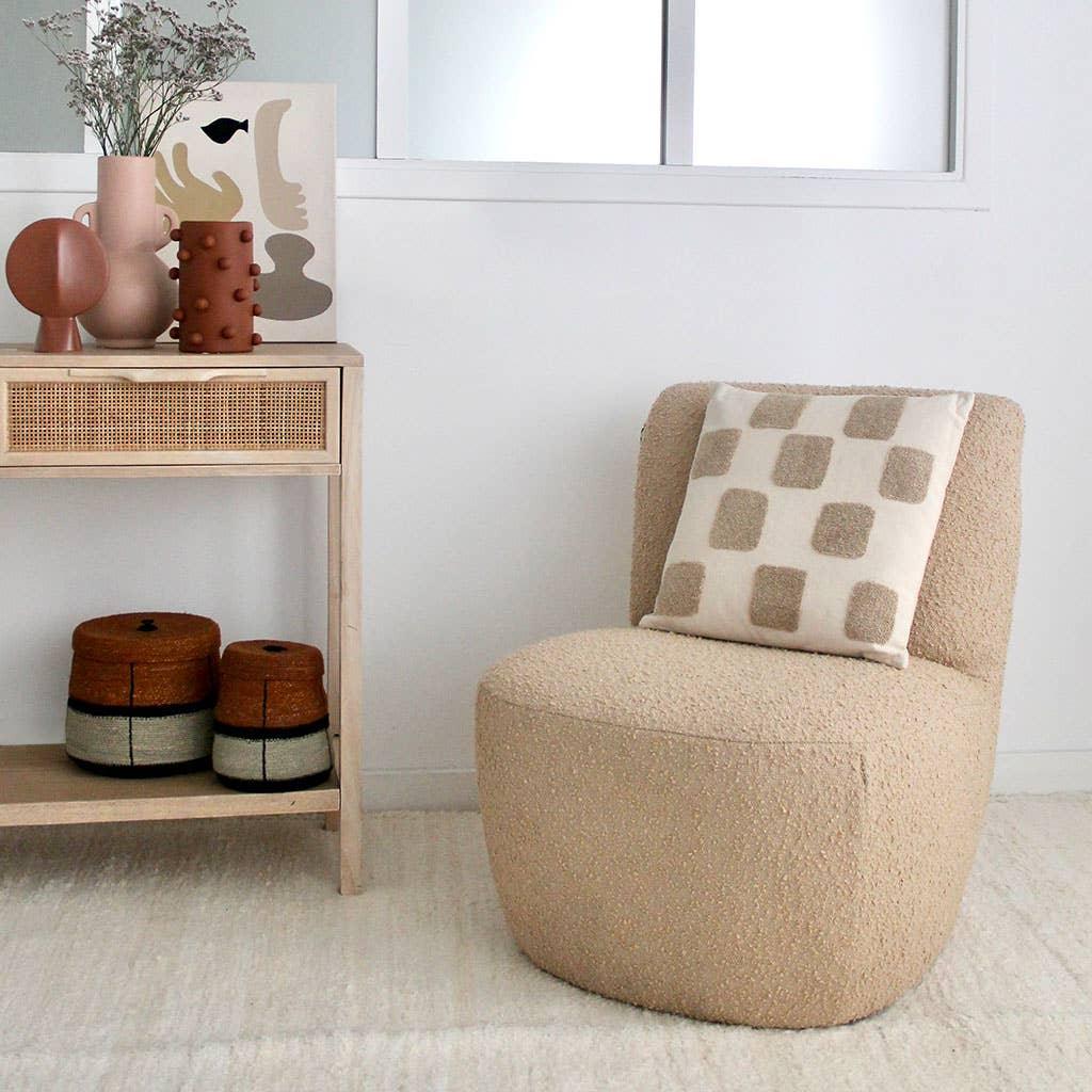 Nodi boucle chair in beige with textured geometric cushion, minimalist modern decor