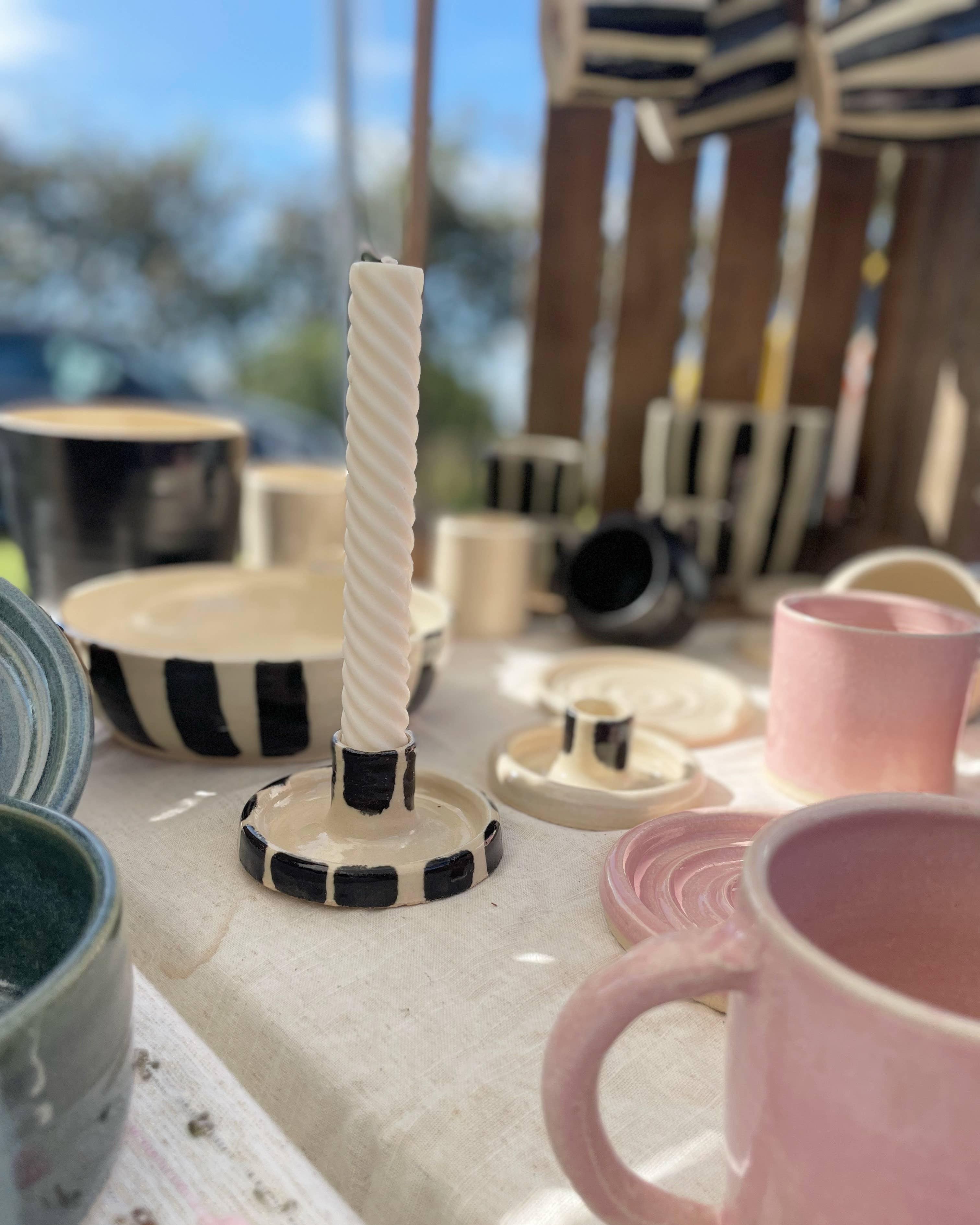 Minka Ceramic Studio striped ceramic candle holder with ivory candle, pink and green ceramic cups