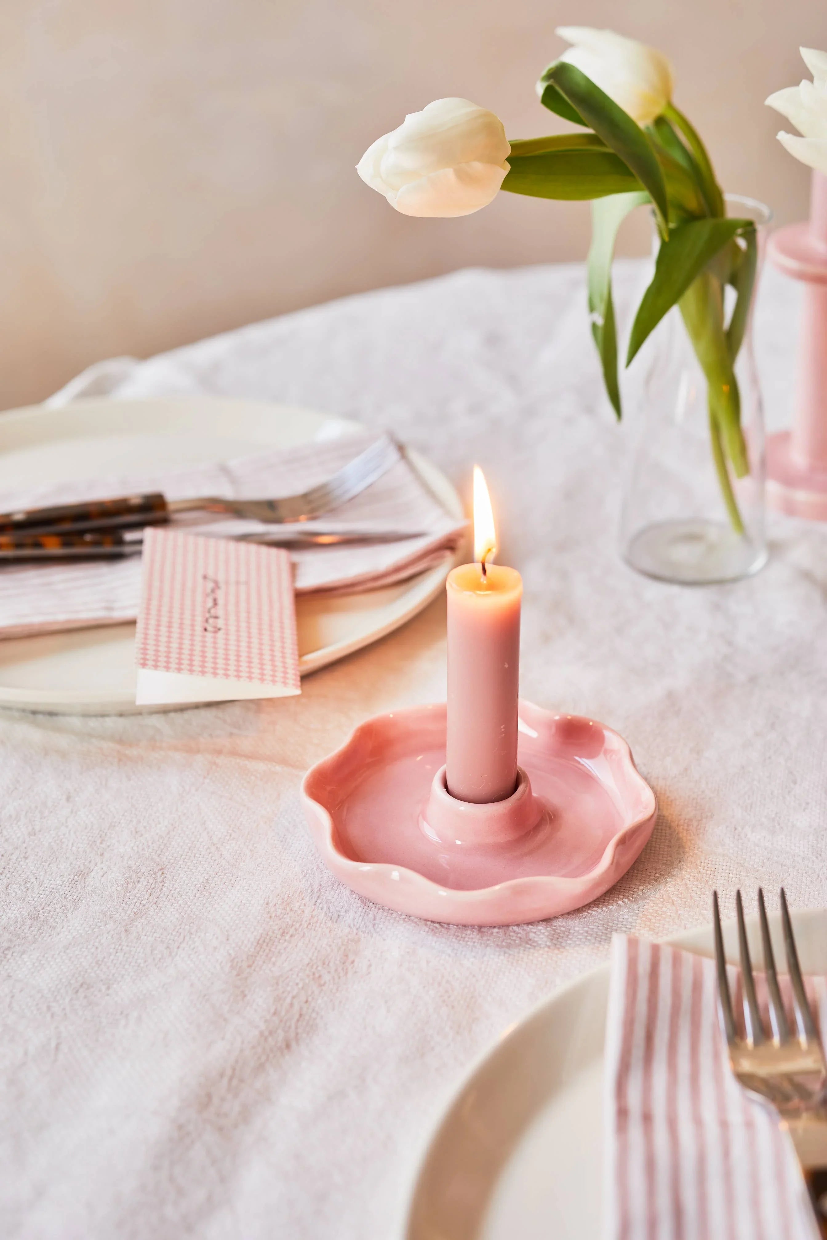 Aeyre pink ceramic candle holder with pink candle on elegant table setting