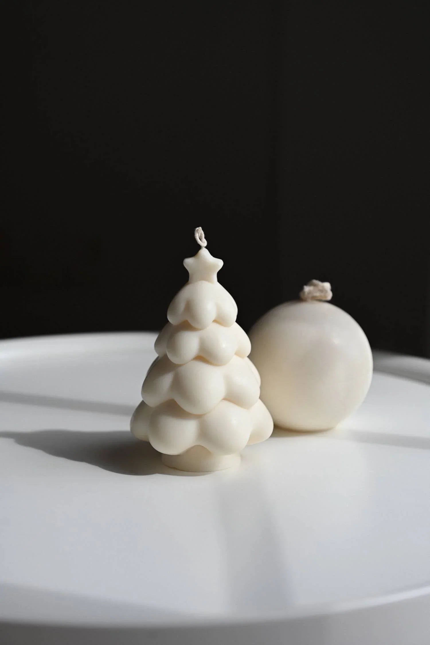 Sundy Studio white soy wax Christmas tree and sphere candles on white tray