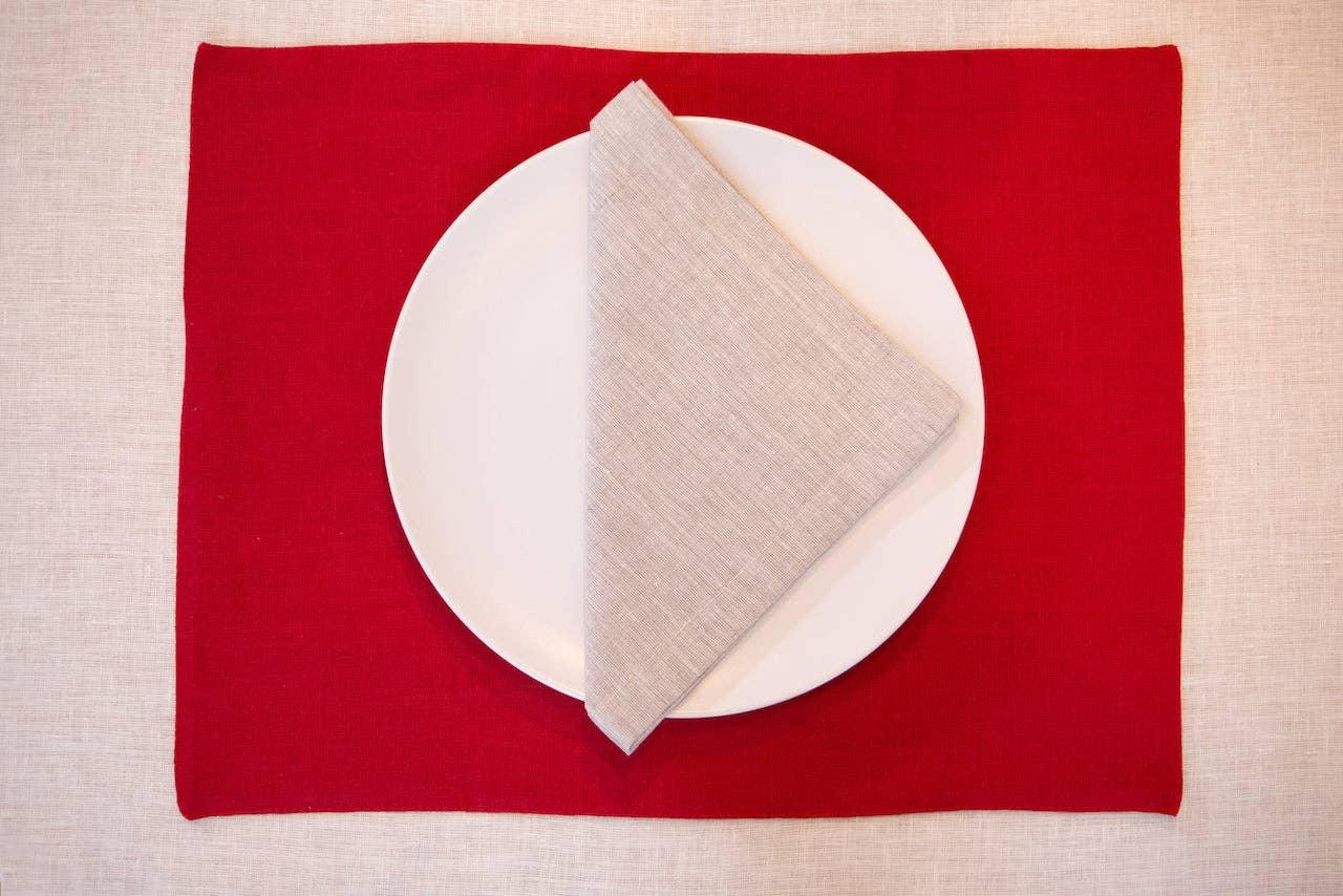 LinenTales red linen placemat with white plate and beige linen napkin, minimalist setting