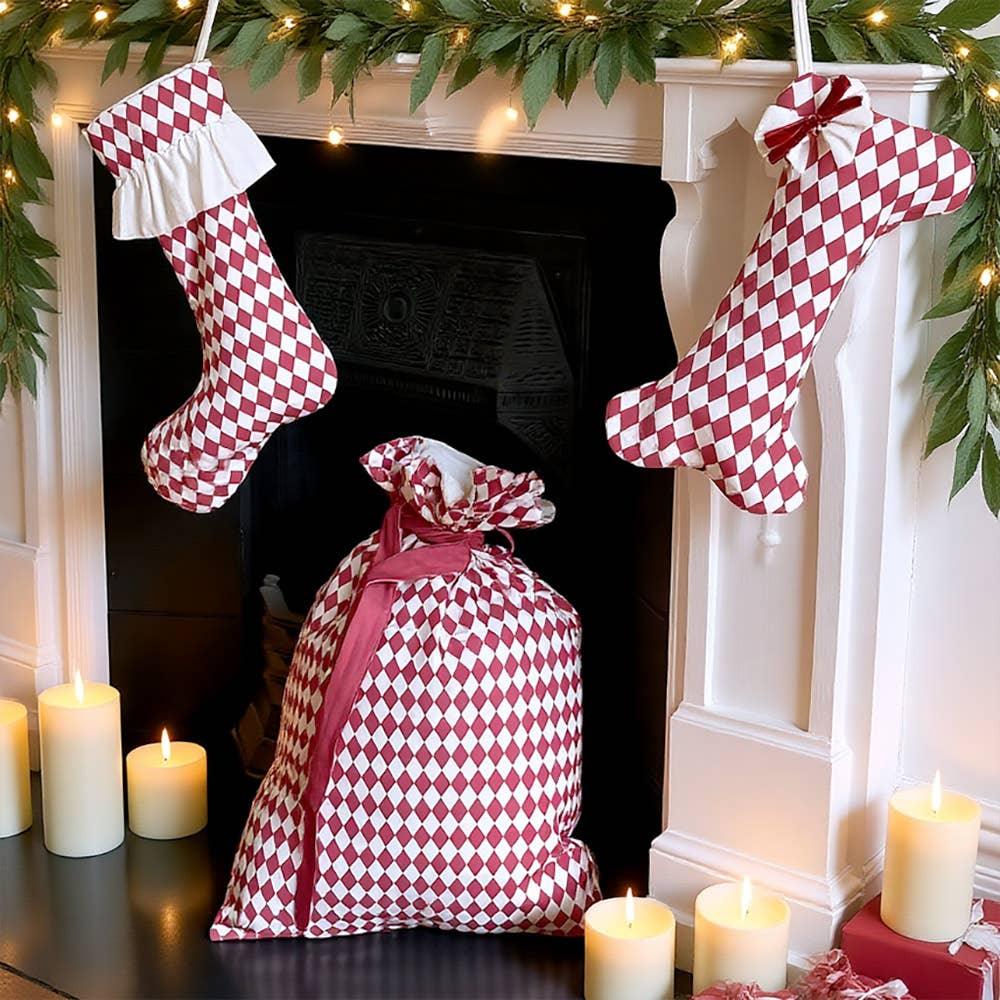 Sarah Raven red and white cotton Christmas stockings and gift sack by fireplace