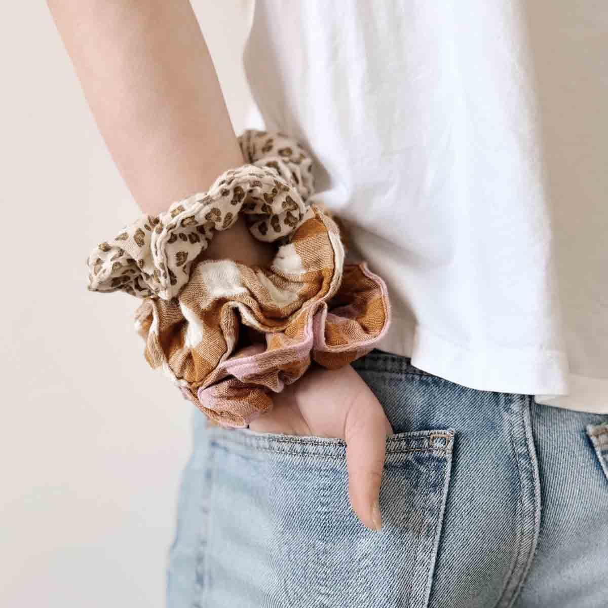 Kindred scrunchies multi-pack in leopard and plaid cotton on wrist, casual outfit style