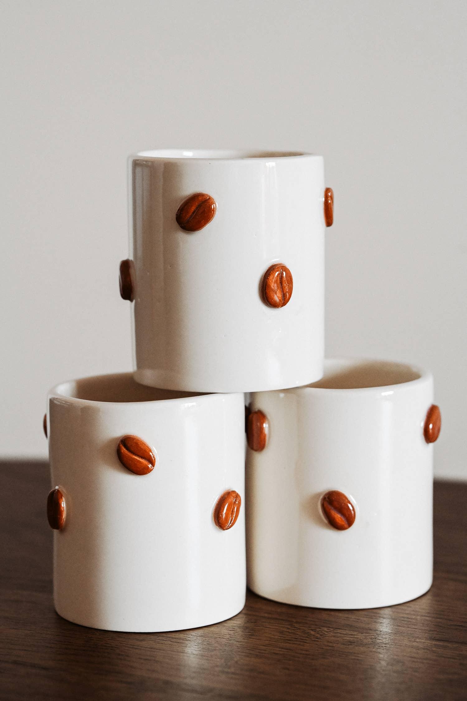 KEIYO ceramic coffee cups with brown coffee bean accents, white finish, stack on wood table