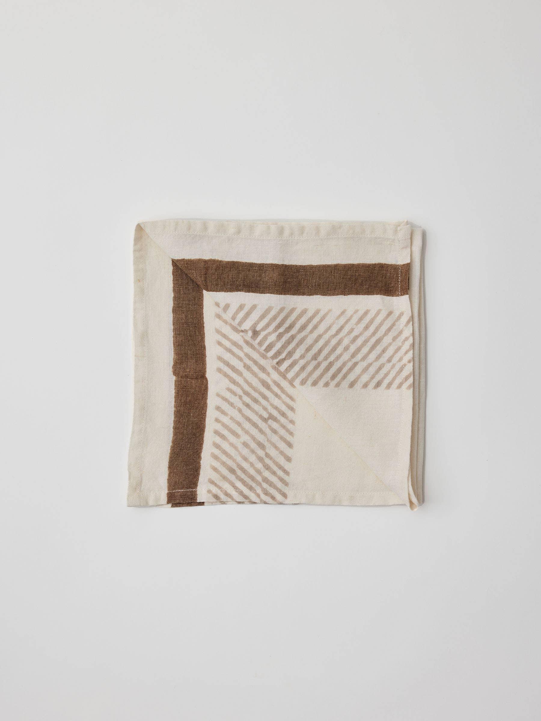 MINNA linen napkin in cream and brown with geometric pattern on white background