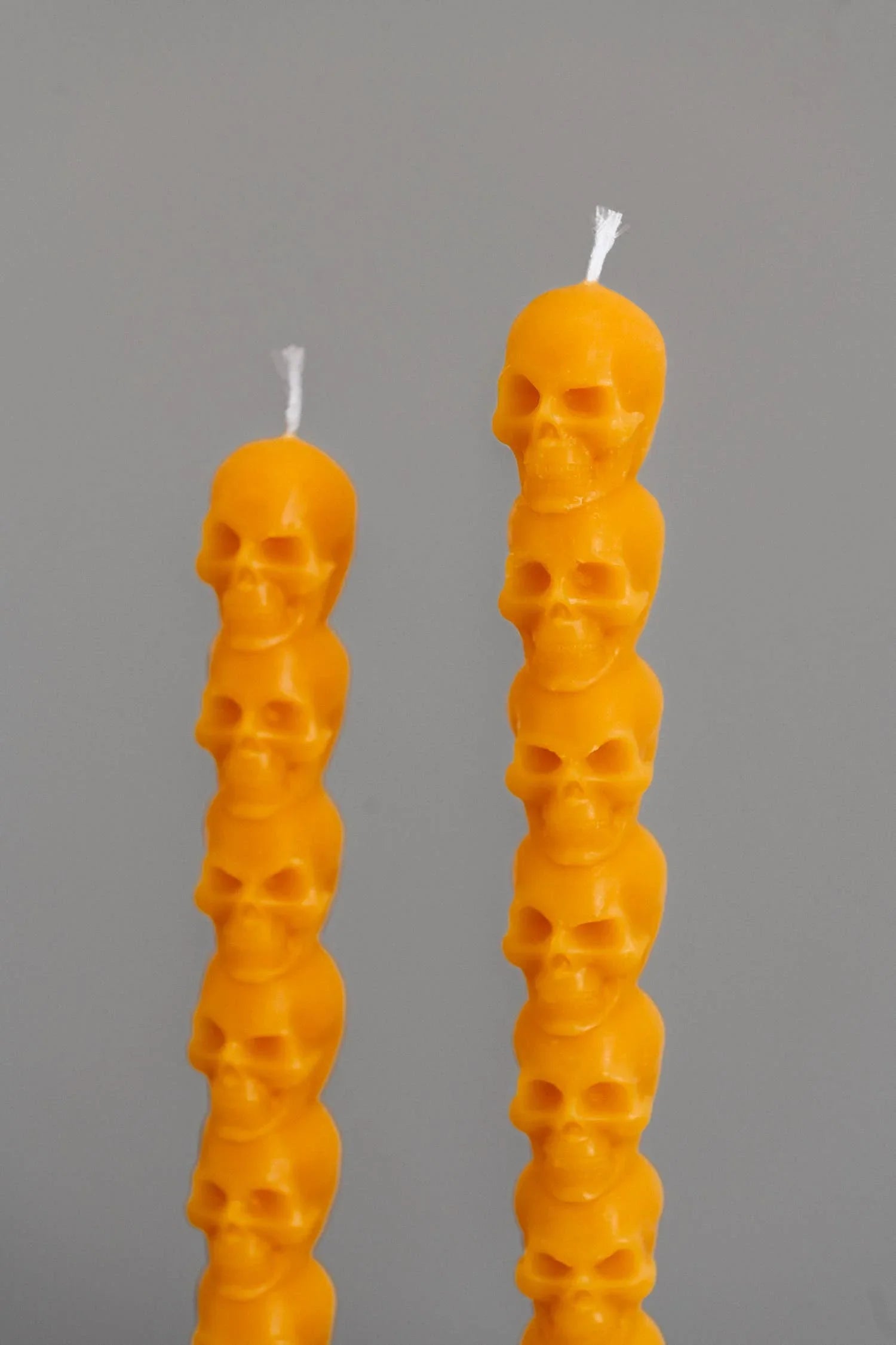 Graveyard Wanders beeswax skull candles in orange, premium handmade candle decor