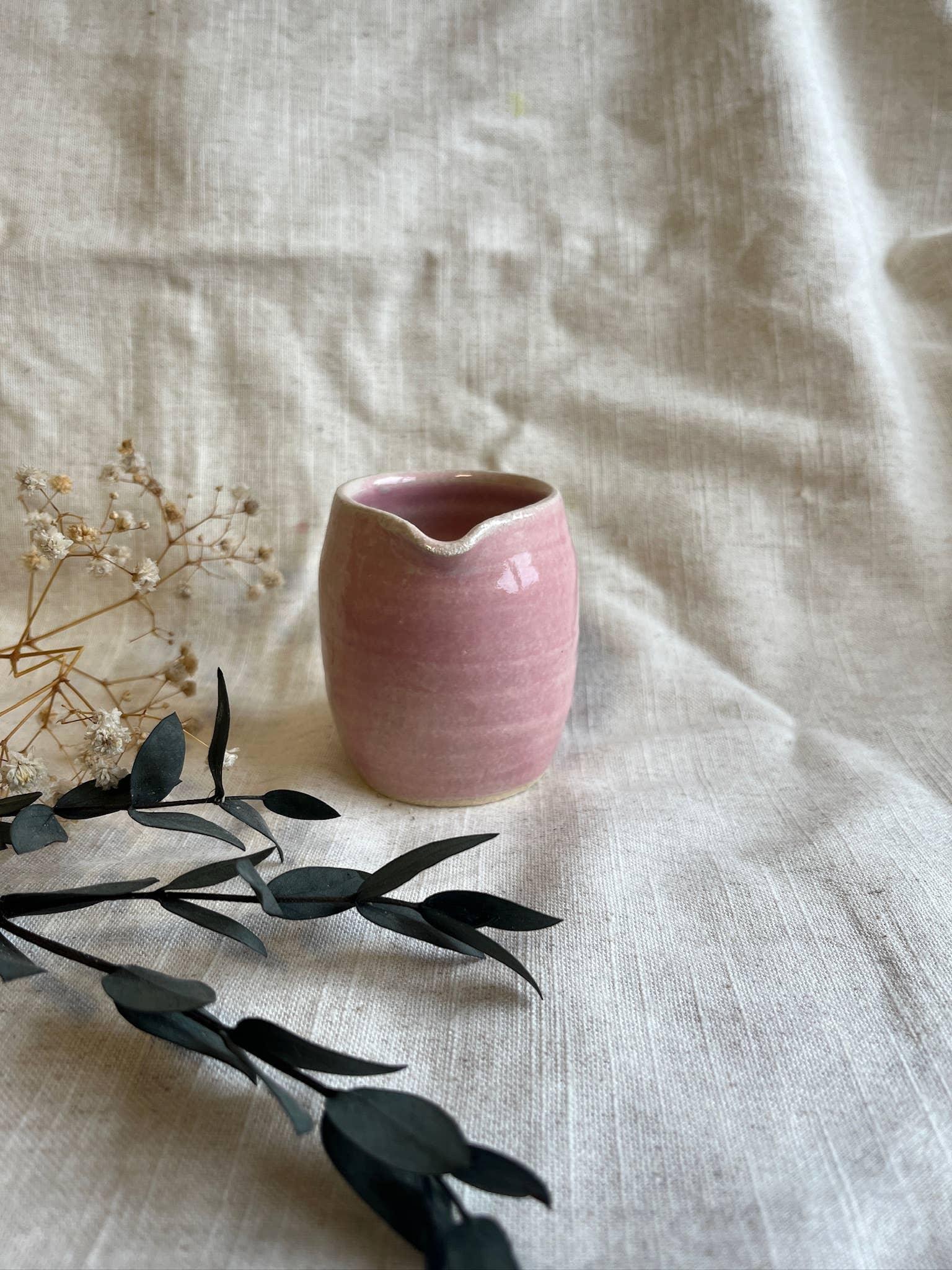 Handmade pink ceramic cup by Ecogami on linen with dried florals