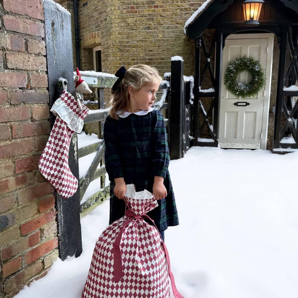 Atelier Choux red diamond Christmas sack and stocking cotton set in snowy outdoor scene