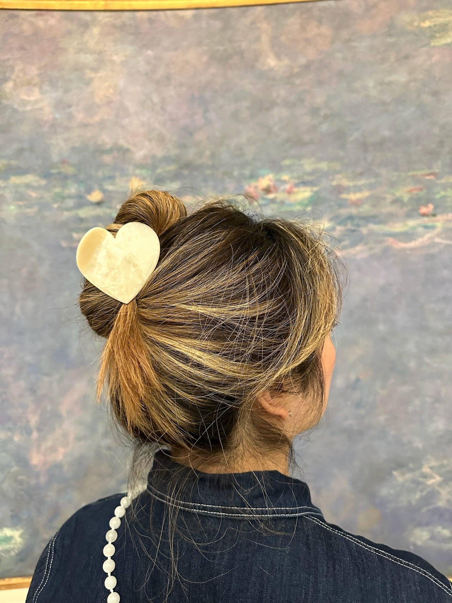 Machihun heart-shaped gold hair clip in resin on brunette hair bun, premium accessory