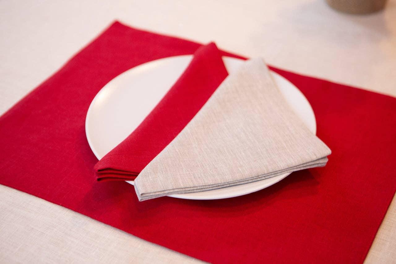 Linen Tales linen placemat and napkin set in red and beige on white plate