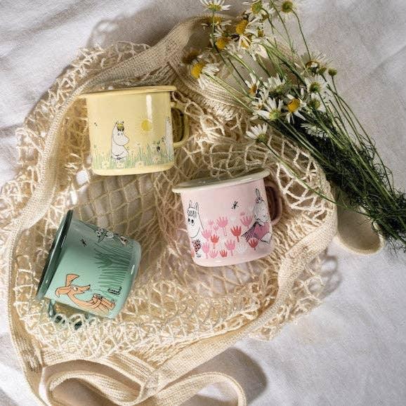 Muurla Moomin enamel mugs in pastel yellow, pink, and green with floral designs on a cotton net bag
