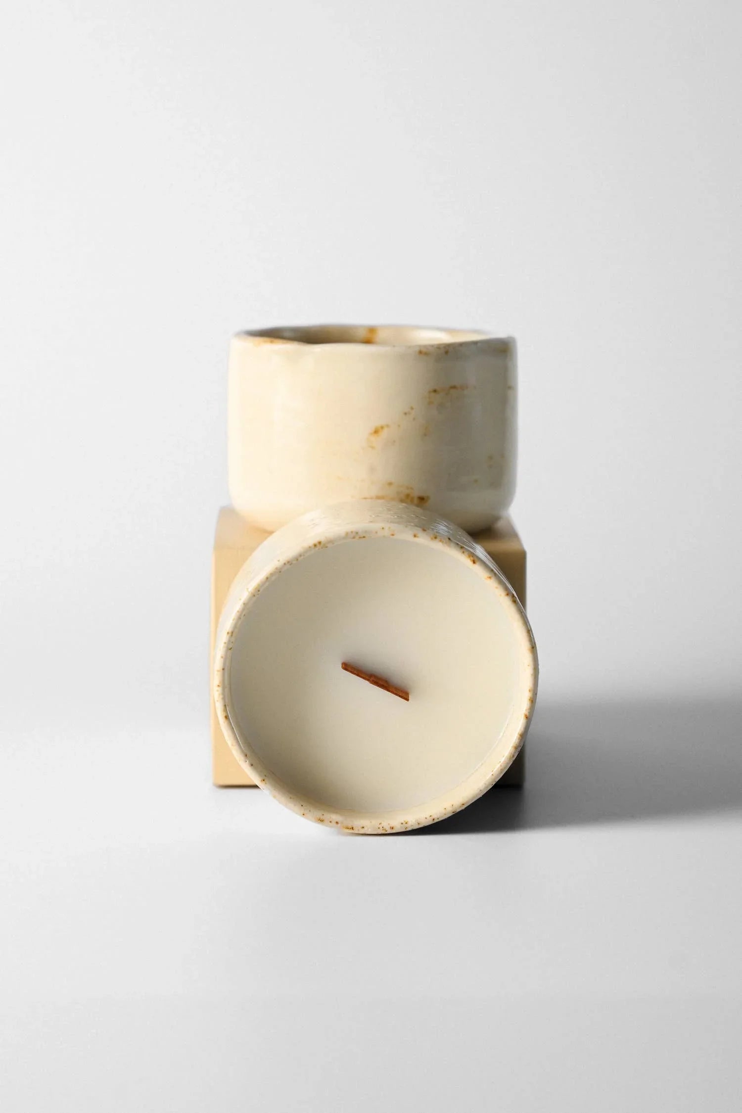 Mar Mar ceramic candle in cream speckled glaze with wood wick on neutral background