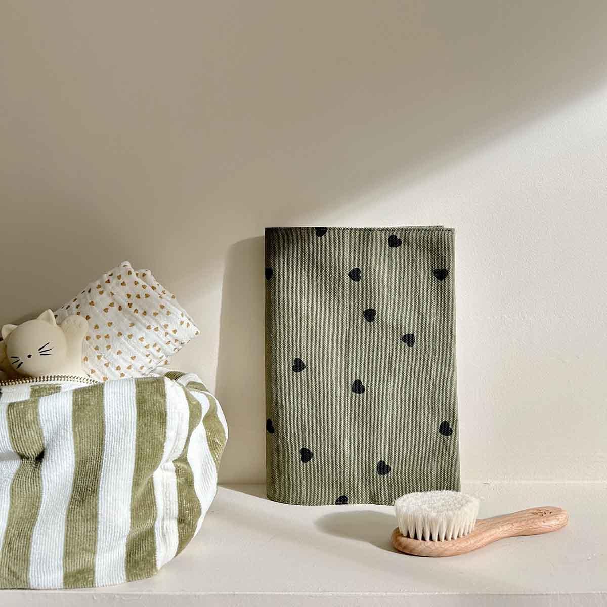 Liewood baby washcloth, cotton olive green with black hearts, striped storage basket, wooden brush