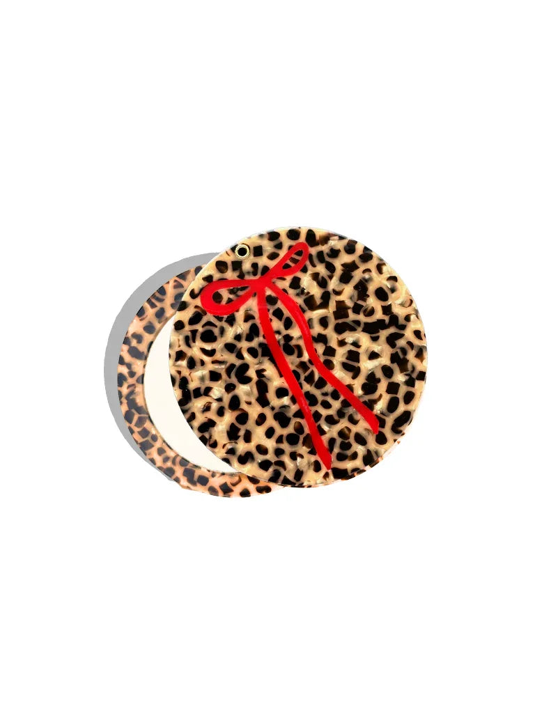 Bow & Crossbones leopard print acrylic brooch with red bow accent