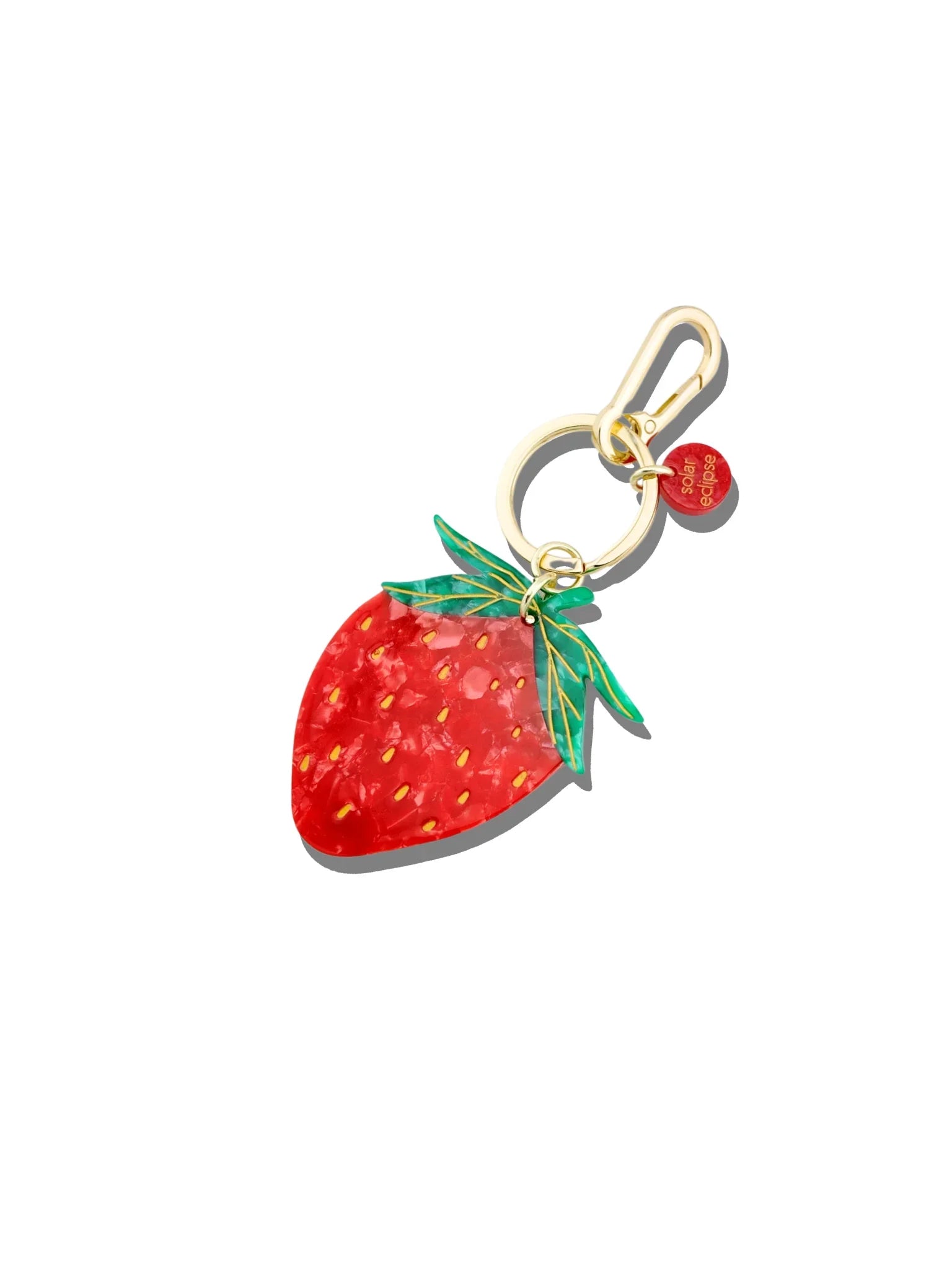 Solar Eclipse strawberry acrylic keychain with gold hardware and red charm