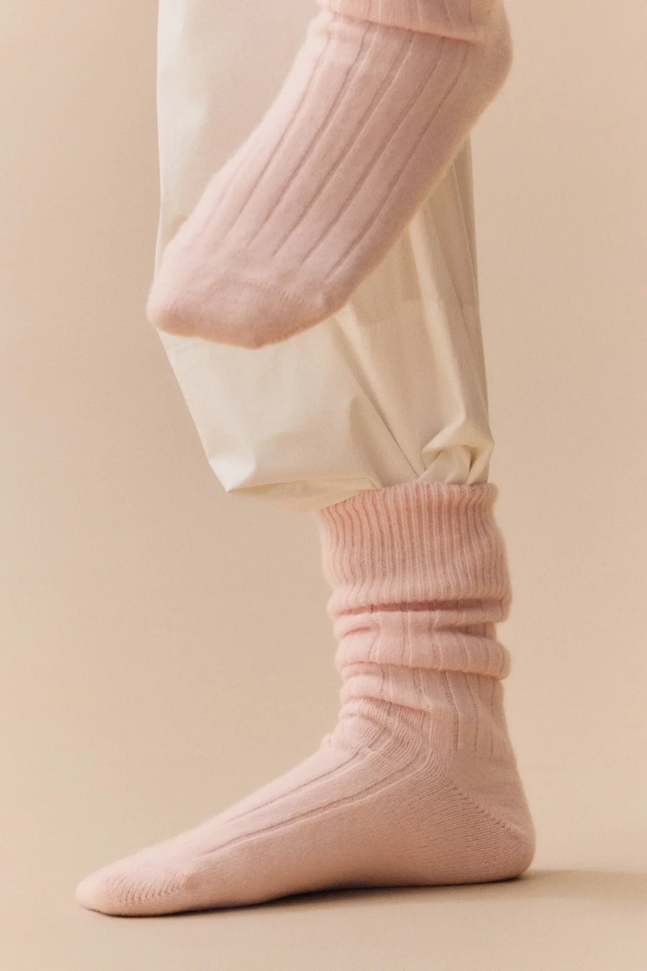 Le Bon Shoppe pink ribbed cashmere socks on model with cream pants
