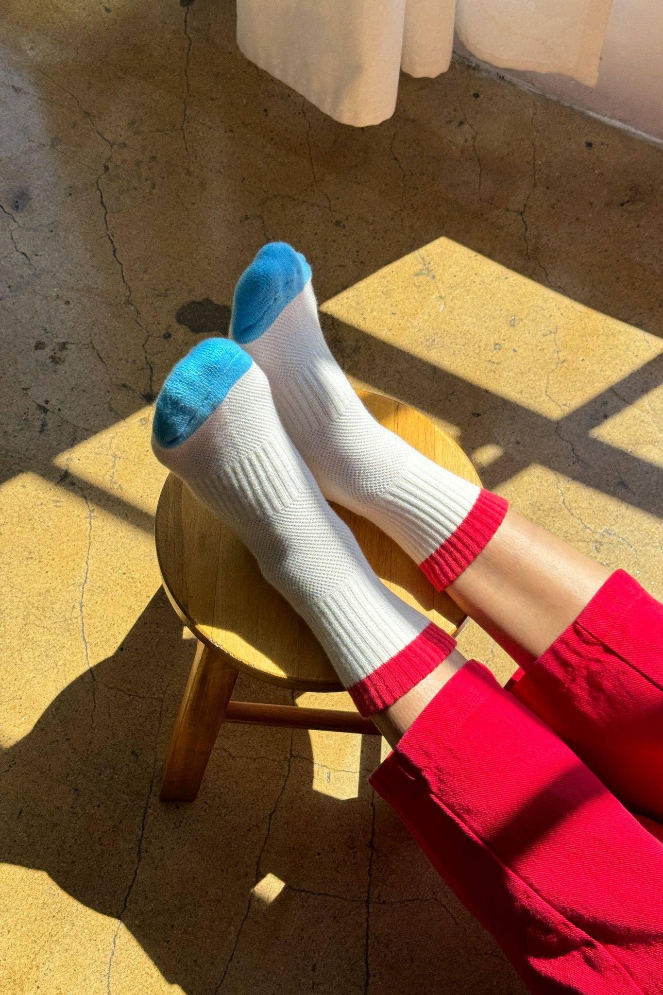 Le Bon Shoppe cotton crew socks, white with red cuff and blue toe, worn indoors