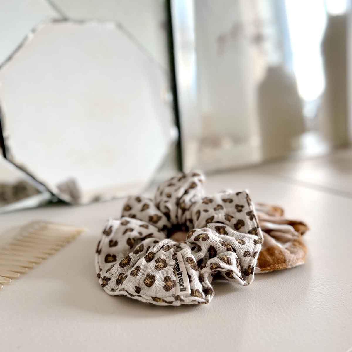 Hello April leopard print cotton scrunchie in white and brown on vanity table