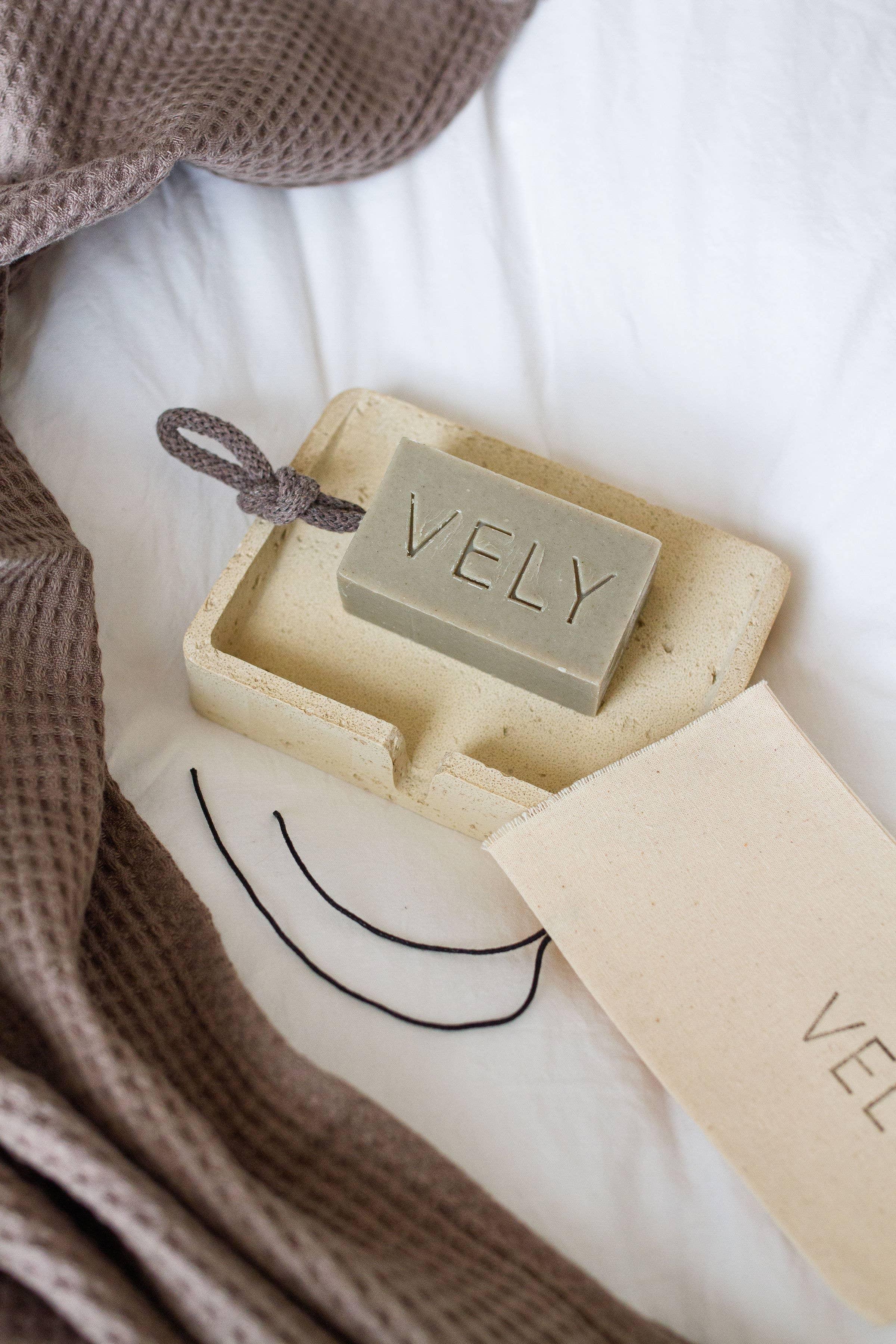 VELY olive green bar soap with rope on beige ceramic tray, waffle towel, premium minimalist style