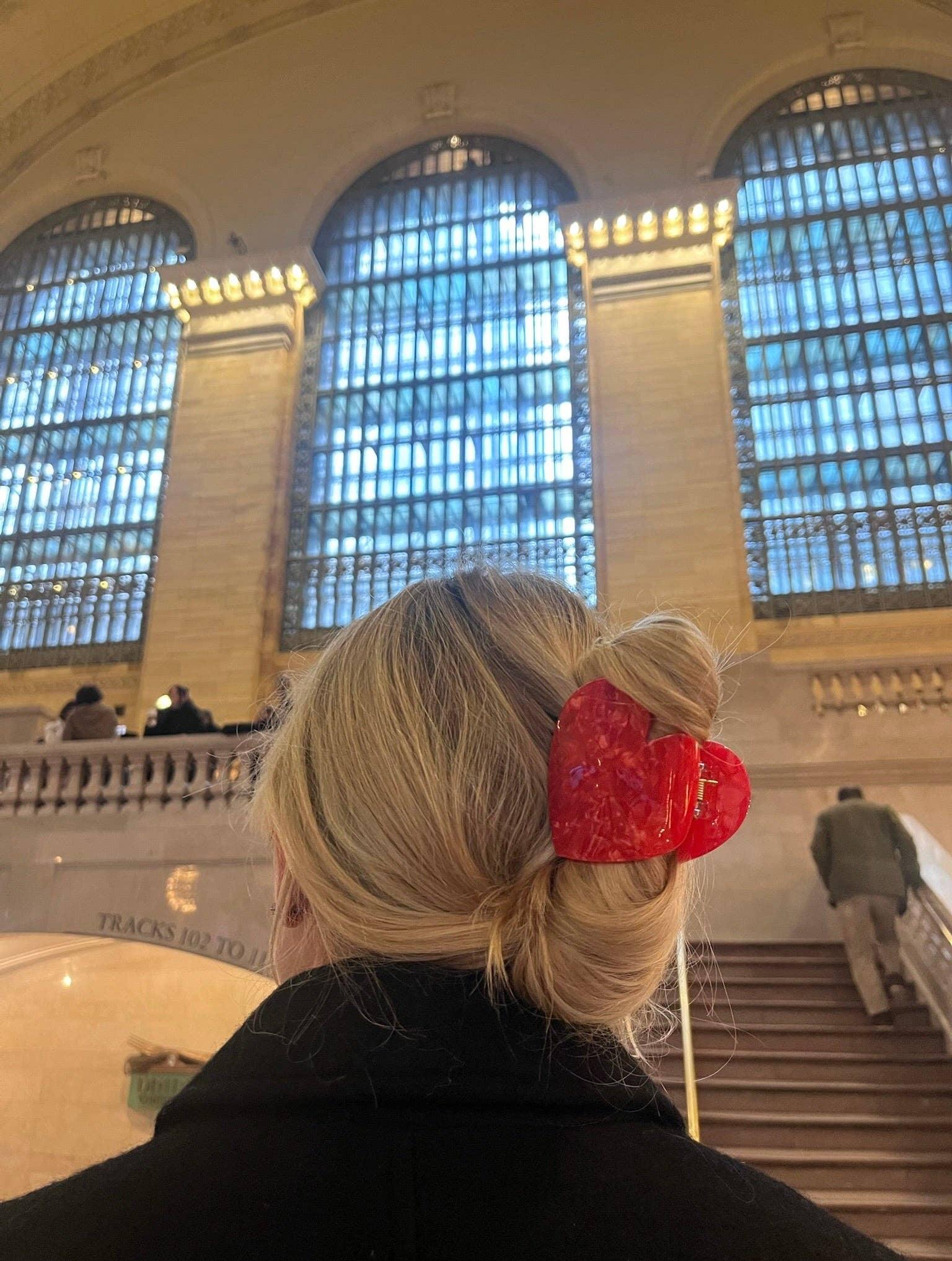 Chunks red heart hair clip in acetate, styled on blonde hair at a historic train station