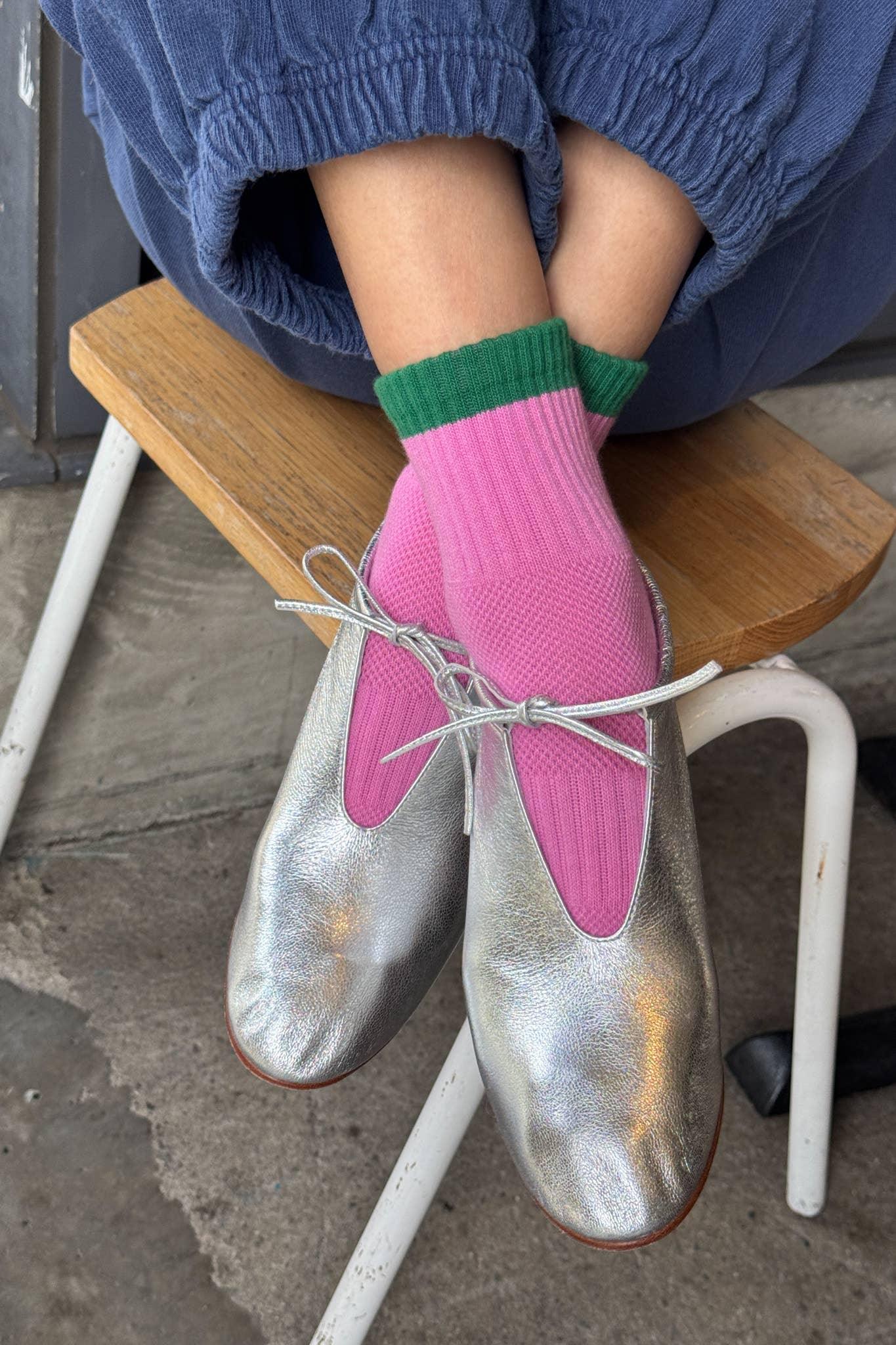 Ballerette silver leather ballet flats with bow detail, worn with pink and green socks